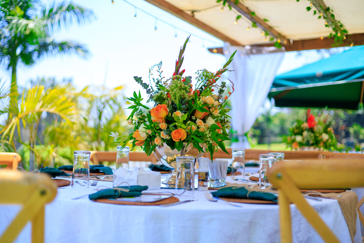 Desk with leather desk pad, walnut desk organizer, wireless keyboard and mouse, and porcelain mug.