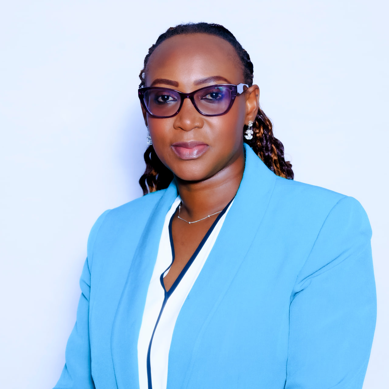 Desk with leather desk pad, walnut desk organizer, wireless keyboard and mouse, and porcelain mug.