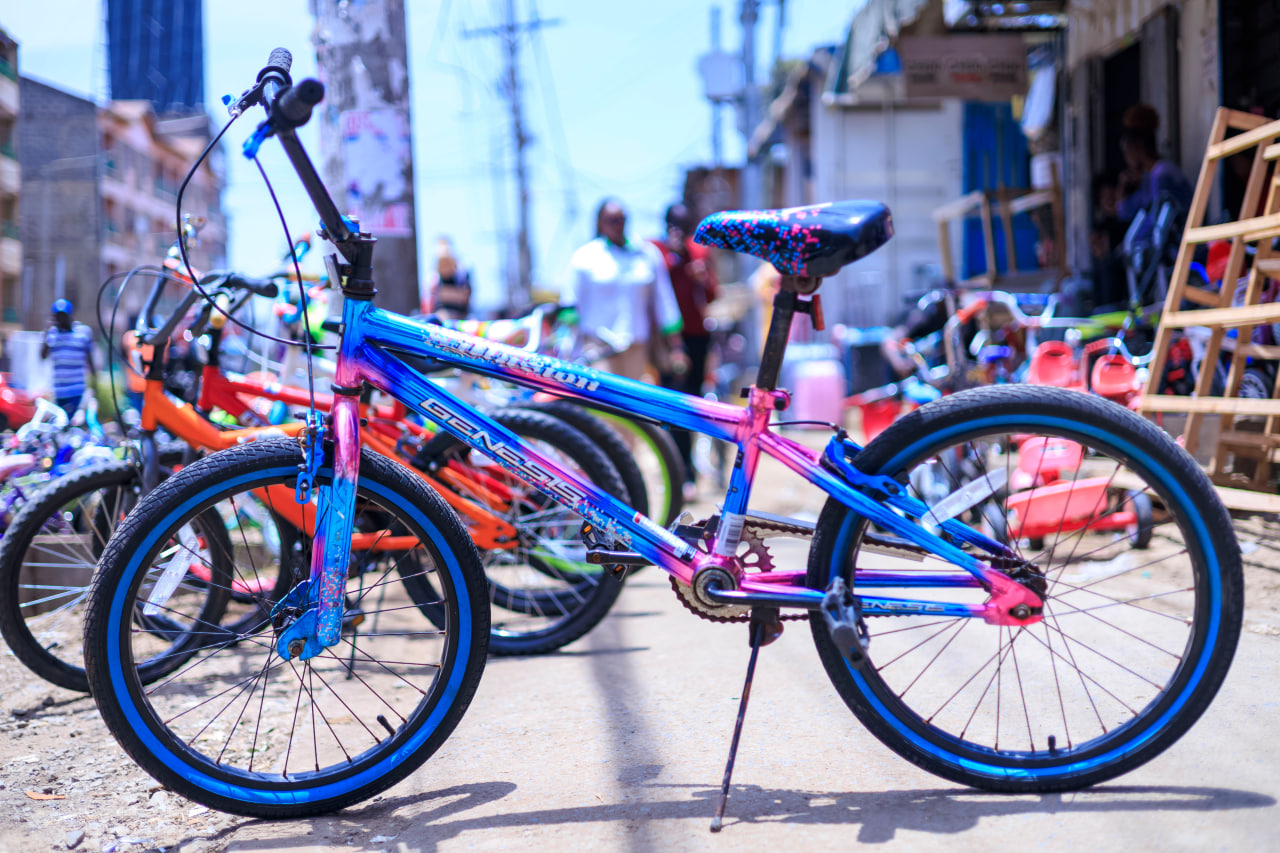 Desk with leather desk pad, walnut desk organizer, wireless keyboard and mouse, and porcelain mug.