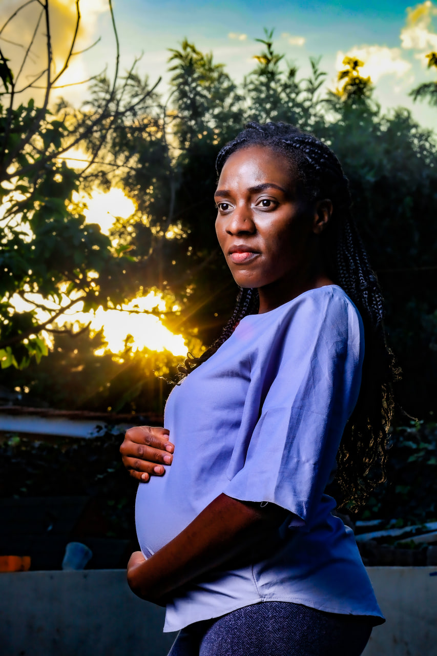 Desk with leather desk pad, walnut desk organizer, wireless keyboard and mouse, and porcelain mug.