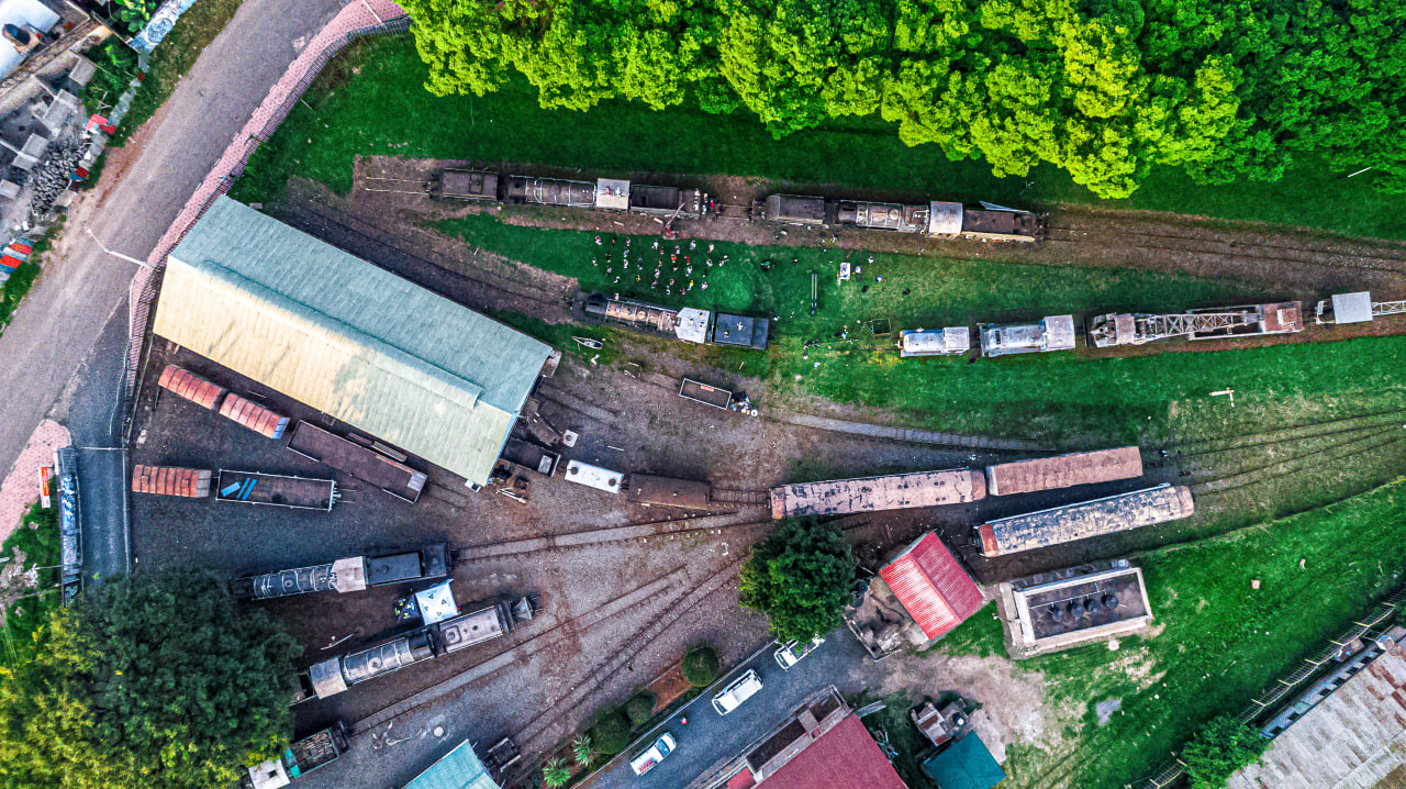 White canvas laptop sleeve with gray felt interior, silver zipper, and tan leather zipper pull.
